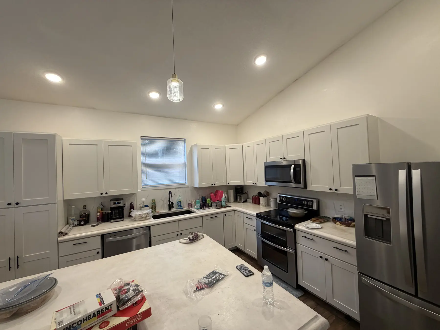 Kitchen with gray painted cabinets and freshly painted white walls and ceiling