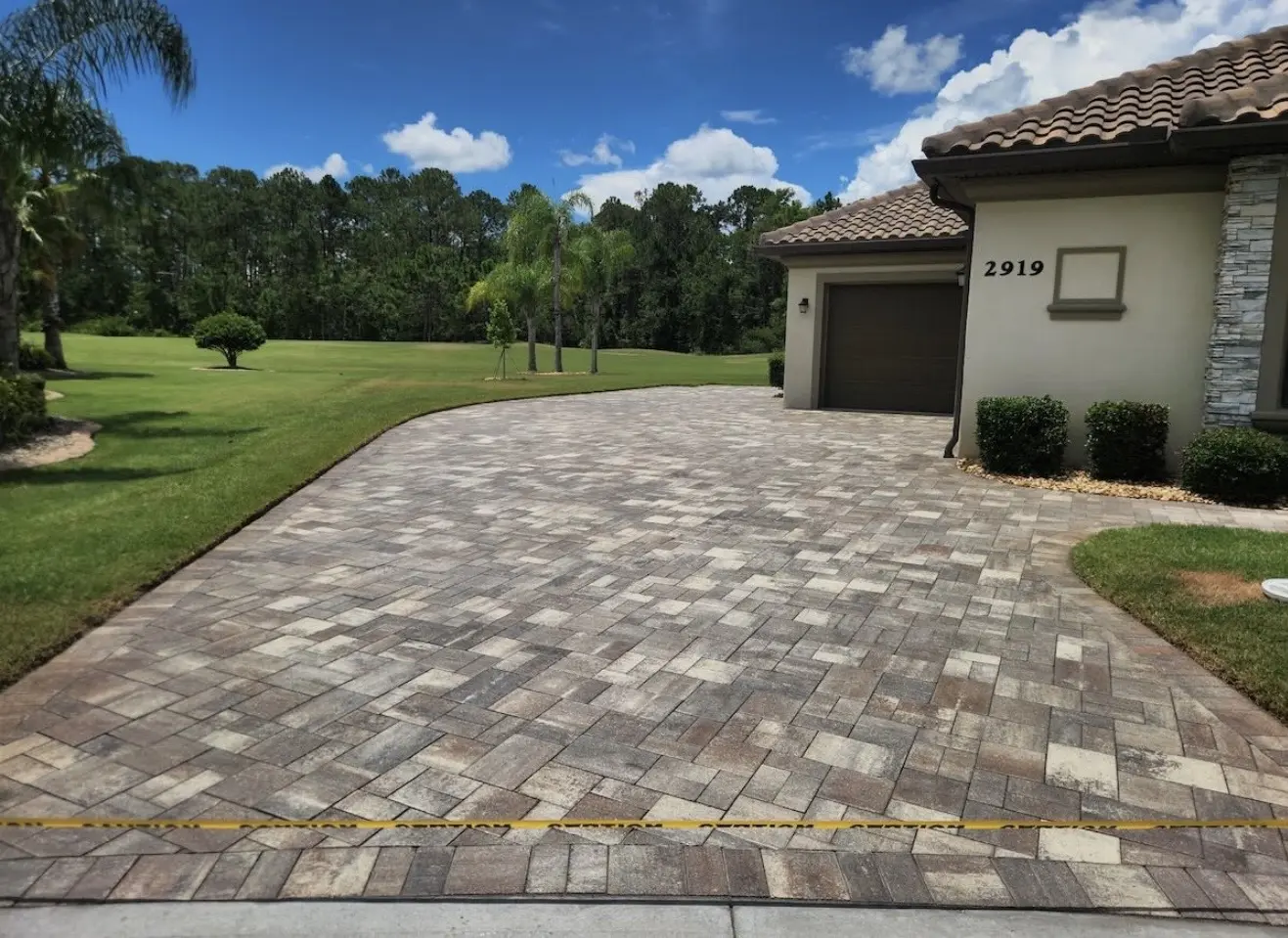 Paver driveway restored with fresh joint sand and sealer
